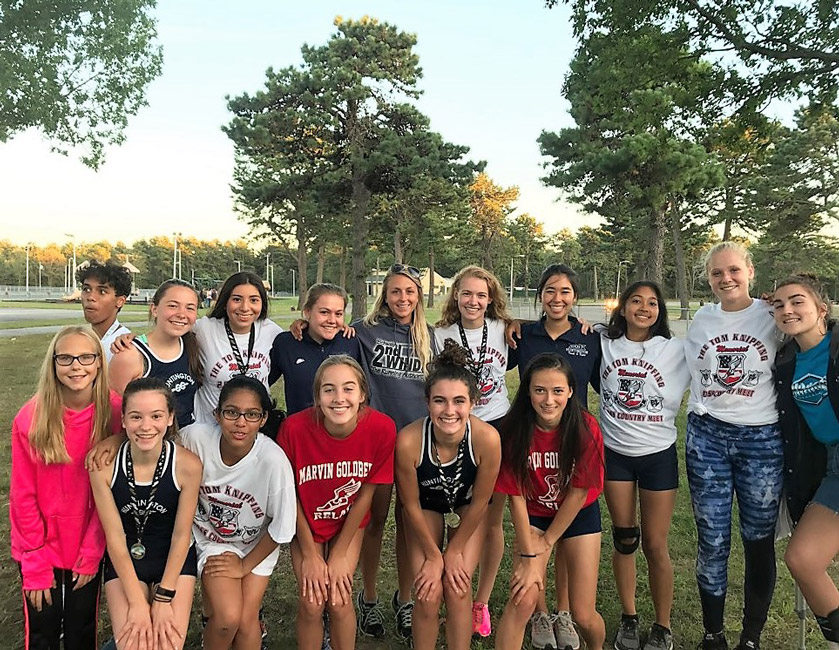 The Huntington girls' cross country team gathers together following a recent meet.