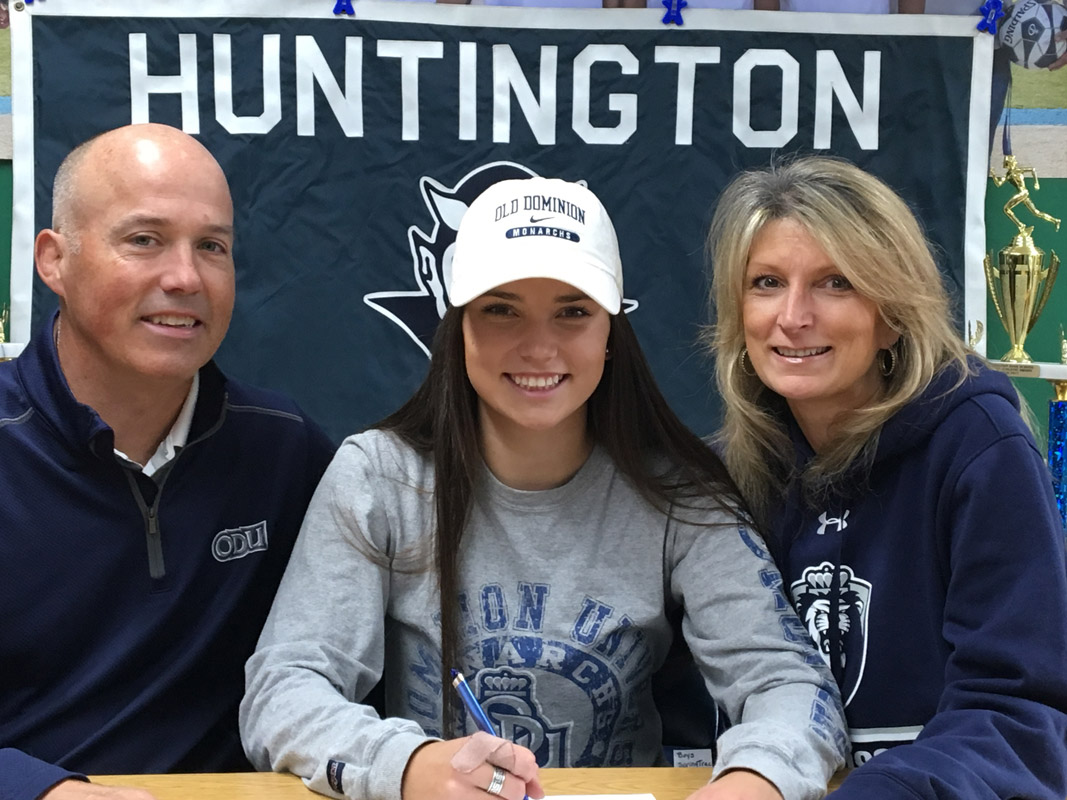 Amber Stieve is flanked by her parents, Paul and Denise at a signing ceremony in the high school athletic office
