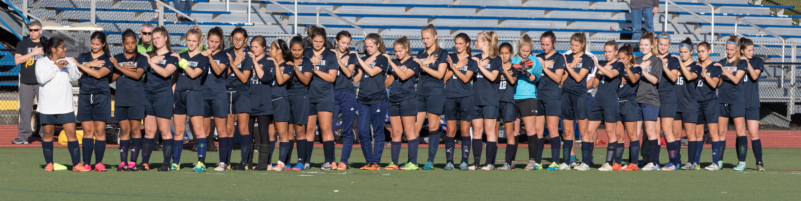 The Huntington girls' soccer team lines up for the national anthem.