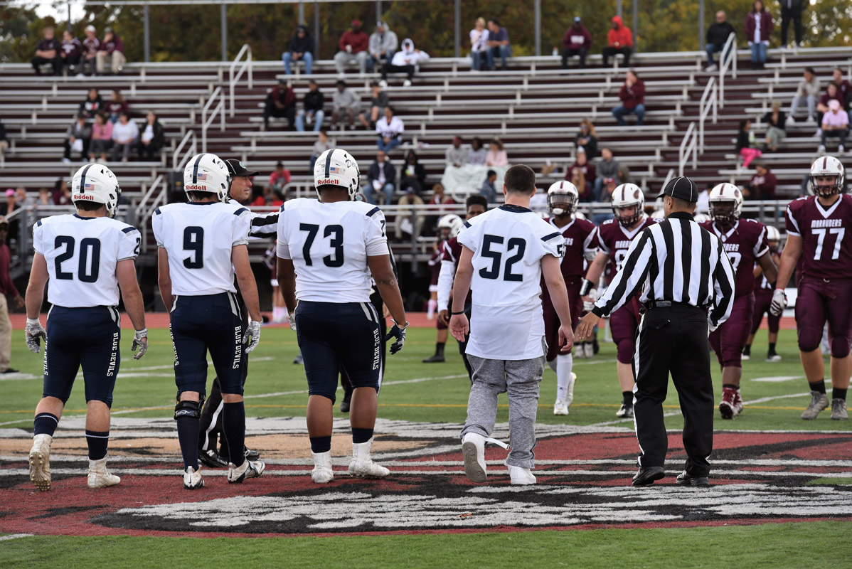Huntington captains Sam Bergman, Luke Eidle, Clay Jamison and Anthony McDonald at midfield for the coin toss.