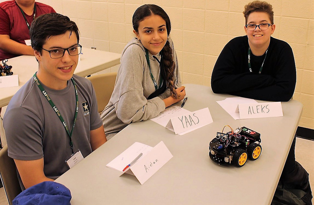 Aidan McCooey and his teammates with their robot at LIU Post. 