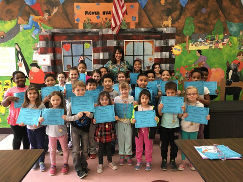 Principal Lucia Laguarda with Flower Hill School's Star Student Award recipients.