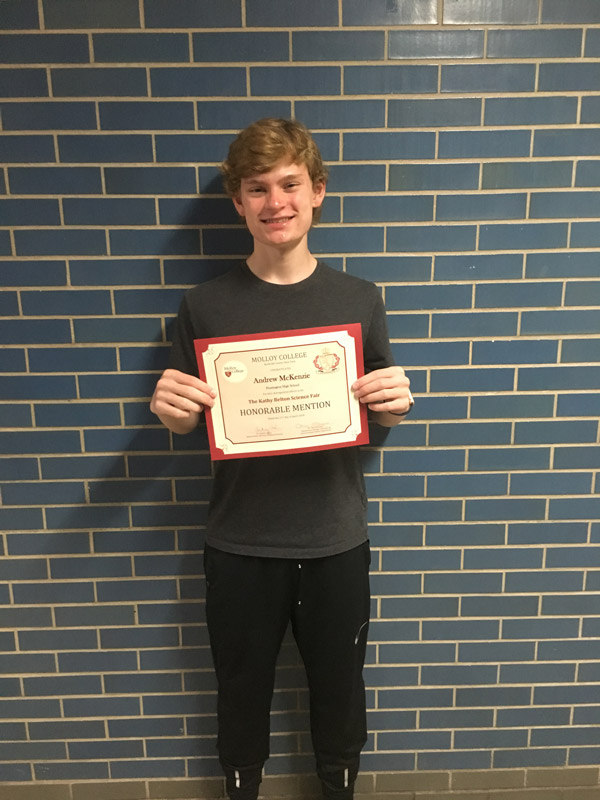 Huntington freshman Andrew McKenzie holds his award certificate.
