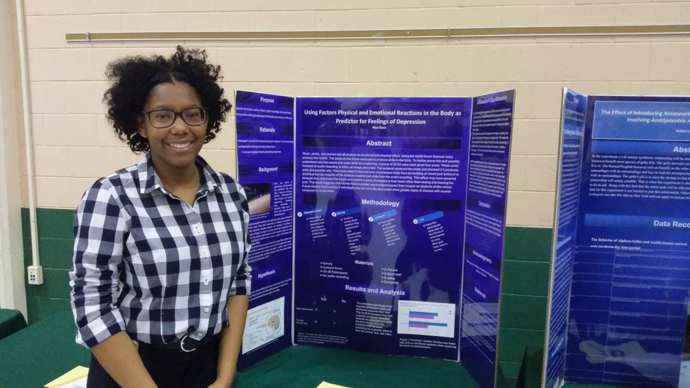 Huntington sophomore Mya Davis with her science project at Farmingdale State College (1).