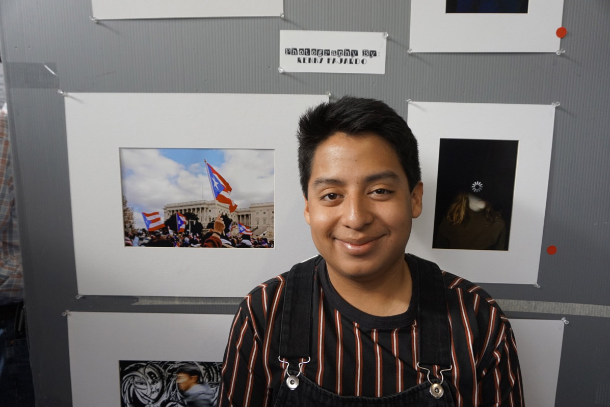 Huntington's Kenny Farjado stands near his photographs on display.