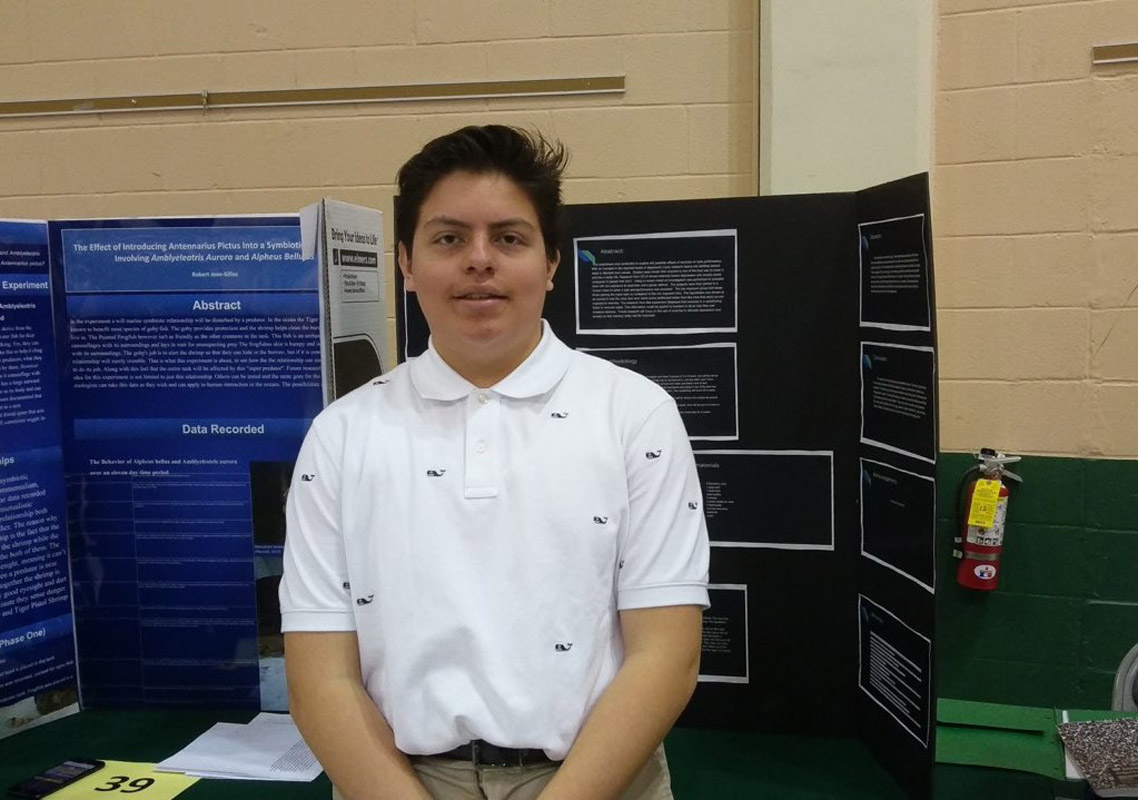 Huntington sophomore Raul Orozco with his project at the STEM Diversity Summit at Farmingdale.