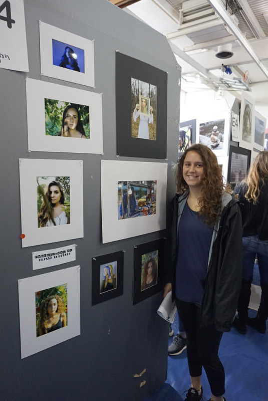 Alyssa Sorensen stands near her dazzling photographs.