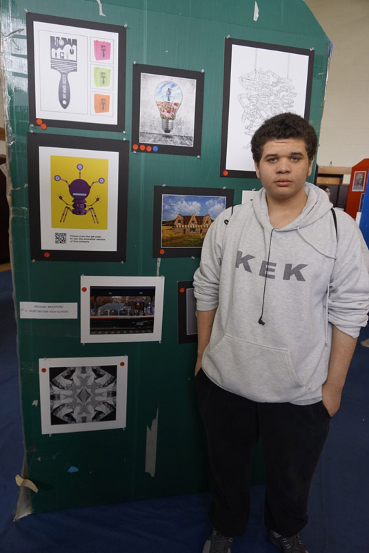 Huntington senior Michael Bradford with his computer graphics images.