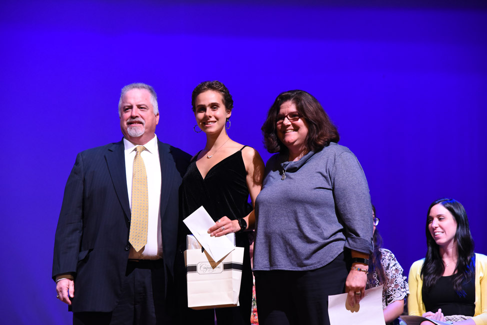 Glen and Anne Manaker flank Christina Nigro at the awards ceremony