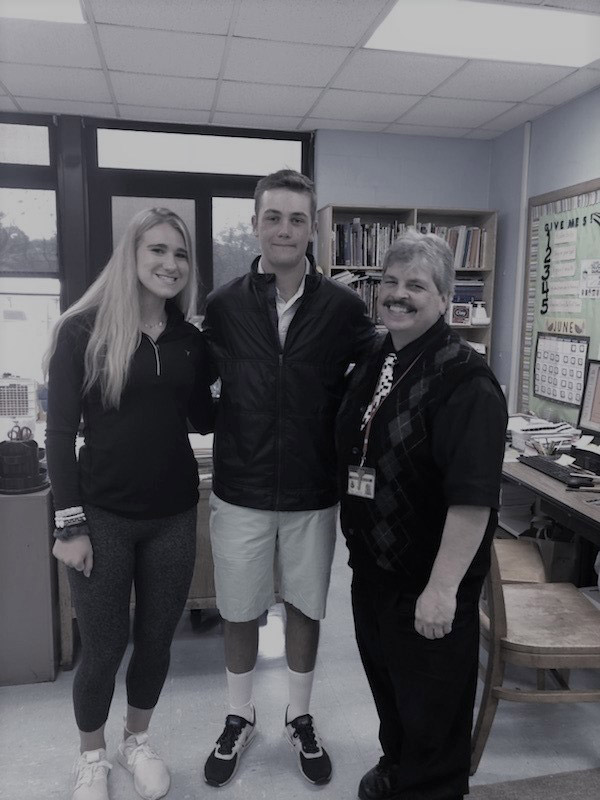 Seniors Katie Seccafico and Tyler Gerbavsits with retiring teacher James Lauter.