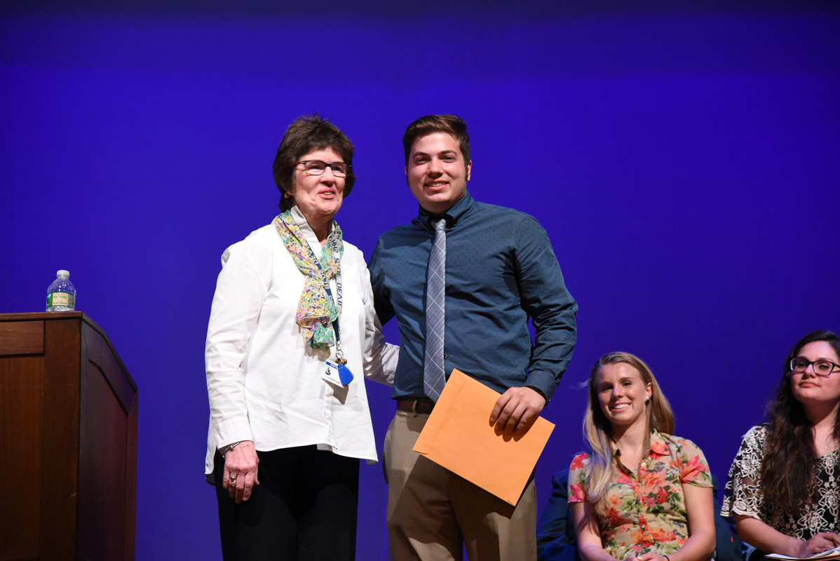 School counselor Catherine Croke presented the County Executive's Public Service Award to John Riley 