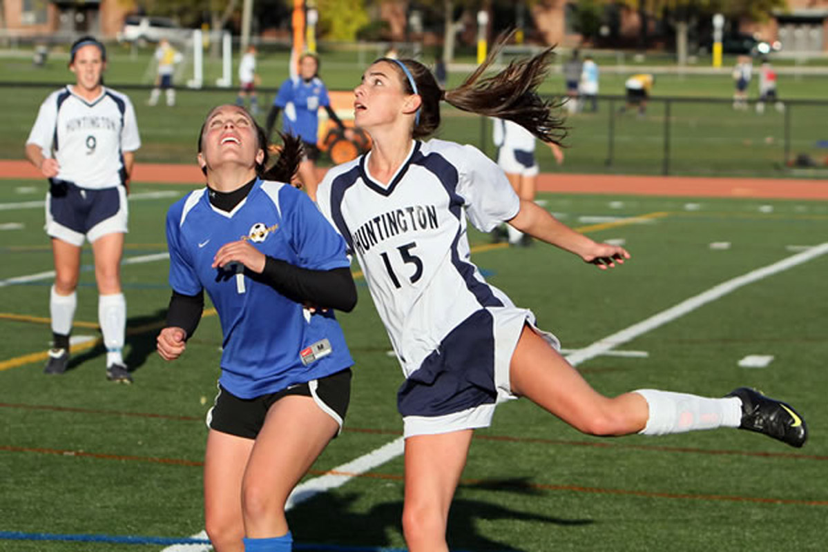 Courtney O'Bryan (right) goes up for the ball for the Blue Devils. (Photo by Mike Connell.)