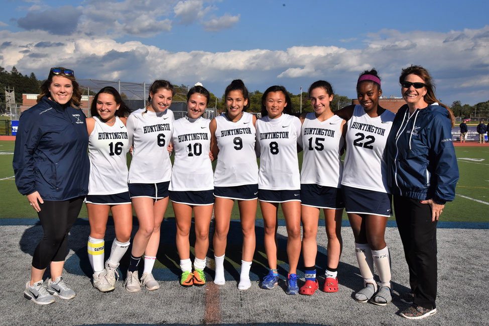 Arielle Harvey (second from right) with her fellow senior teammates and field hockey coaches.