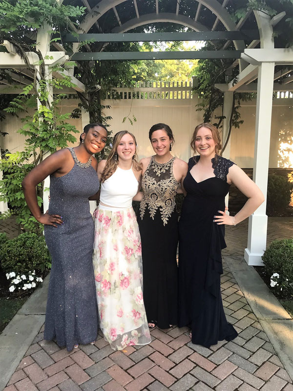 Arielle Harvey (left) with her friends at Huntington's prom.