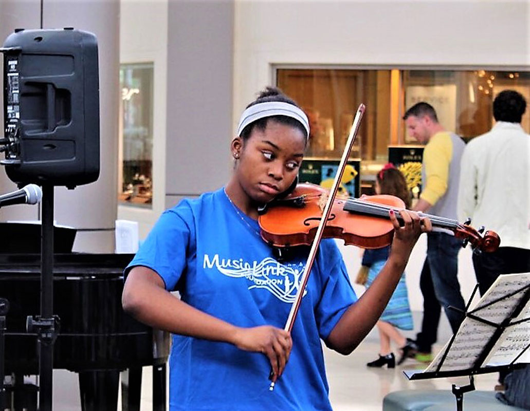 Arielle Harvey rehearses with her violin.