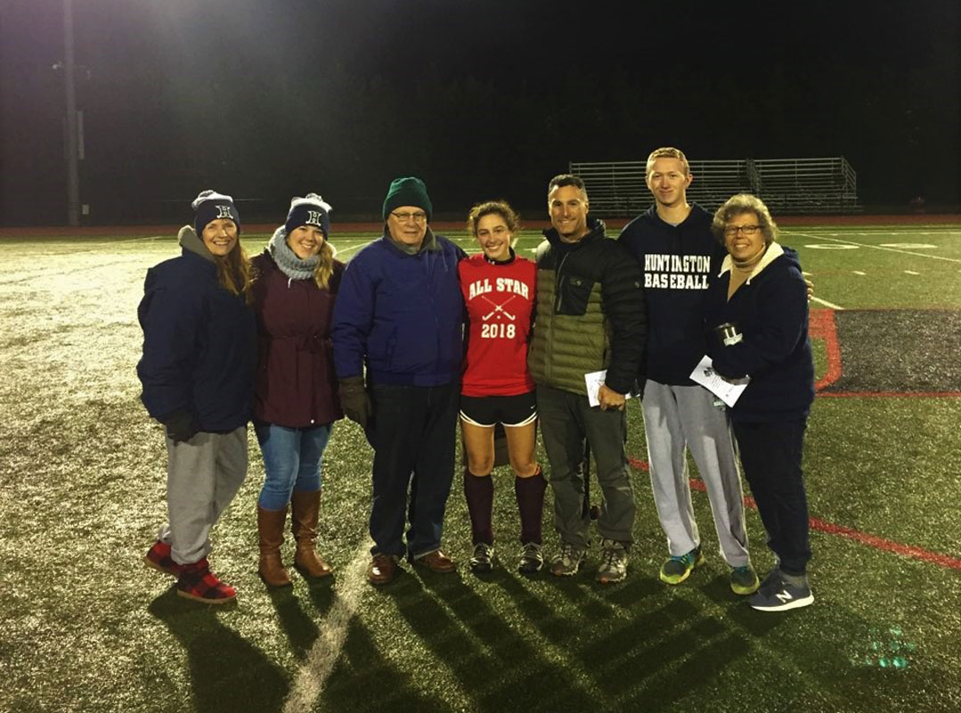Morgan Minicozzi is surrounded by her coaches and family at the Suffolk All-Star field hockey game.