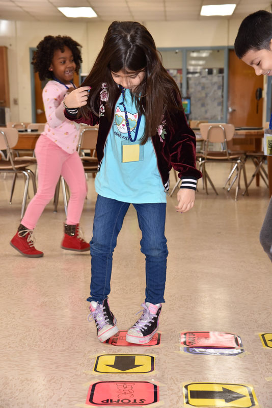 Washington students played hopscotch coding. 
