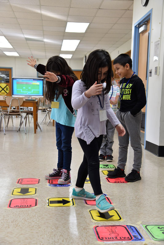 Washington students played hopscotch coding. 