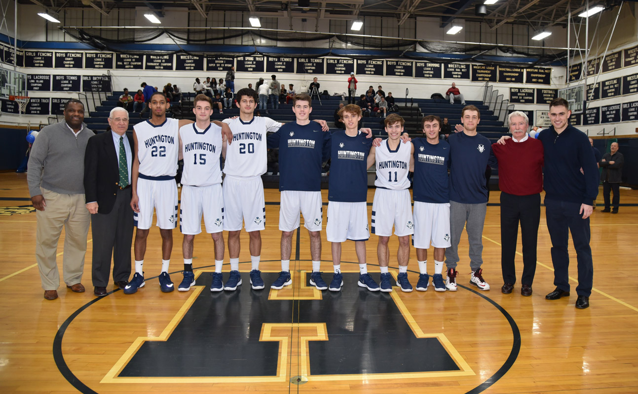 Huntington boys' basketball seniors and Blue Devils coaches on Senior Day in Louis D. Giani Gymnasium.