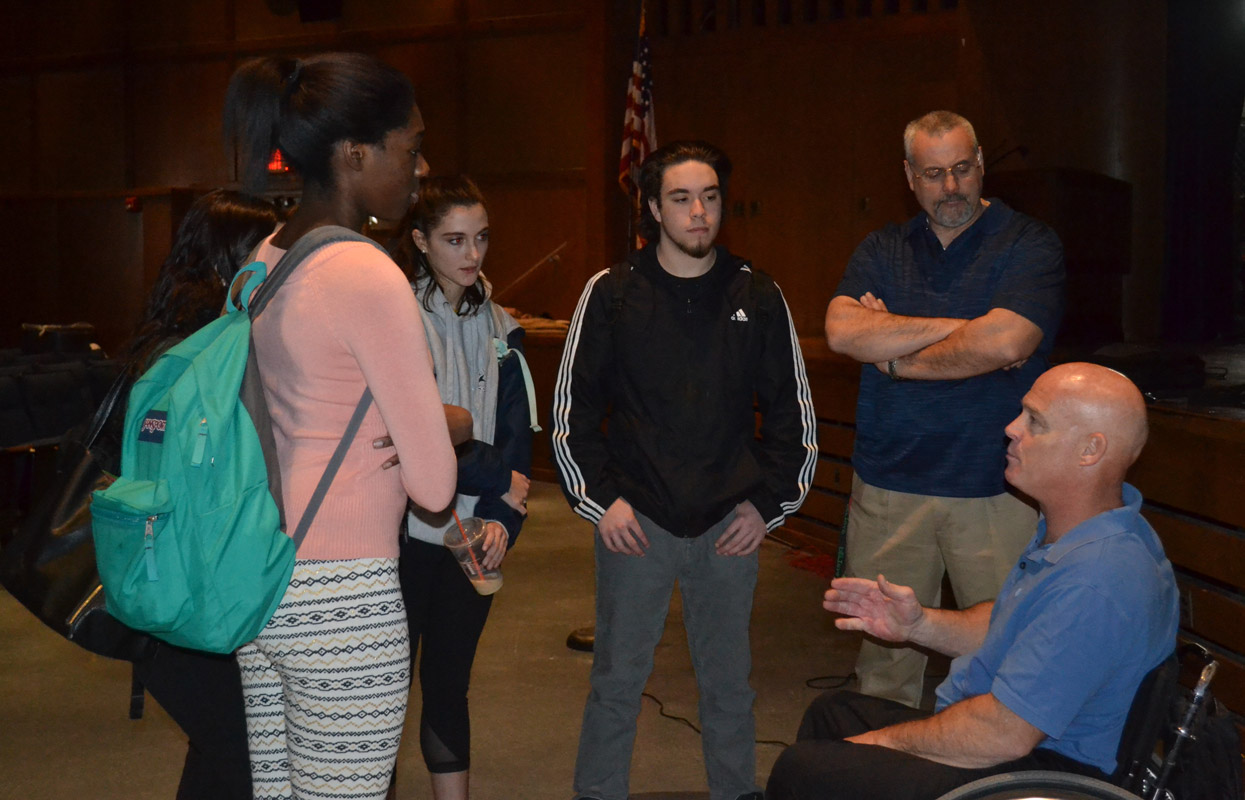 Pete Hawkins speaks with Huntington students and high school Dean Paul Caleca.