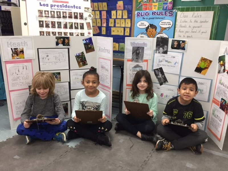 Flower Hill first graders show out their dual language program projects.