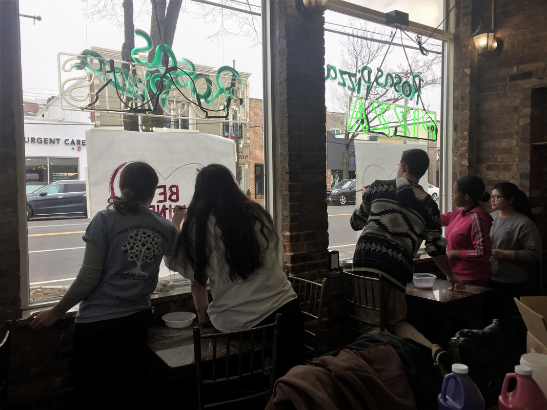 Huntington Art Honor Society members painted the windows at Rosa's Pizzeria for Valentine's Day.