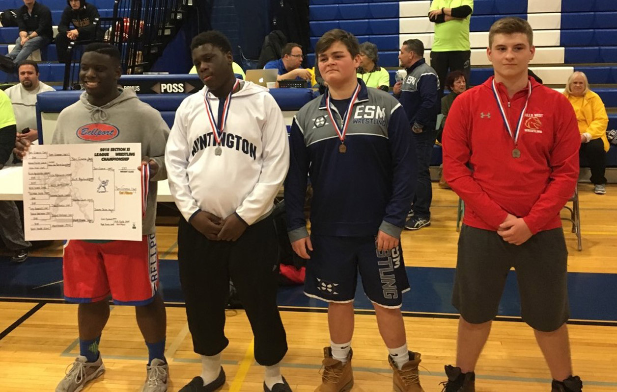 Huntington sophomore Tazedon Smith (second from left) finished second at 170 lbs. in the league tournament.