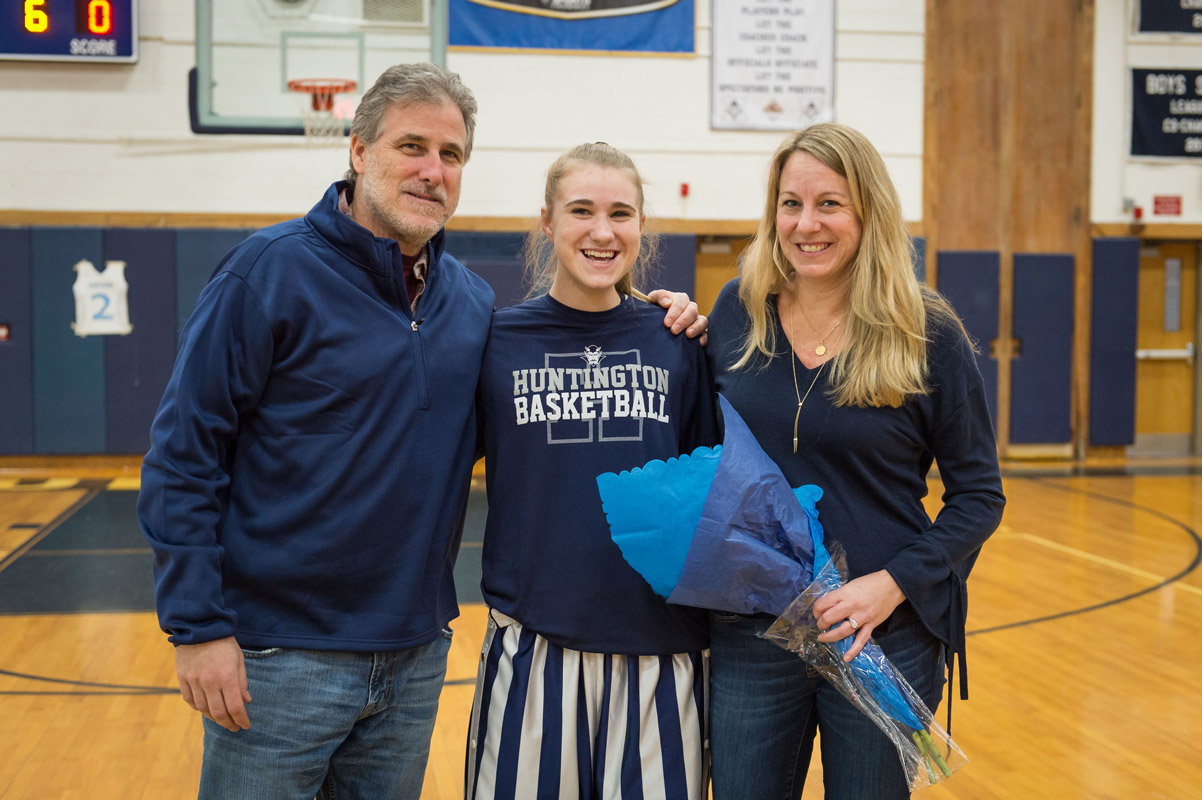 Huntington senior Katie Seccafico is flanked by her parents, Drew and Elke. (Darin Reed photo.)
