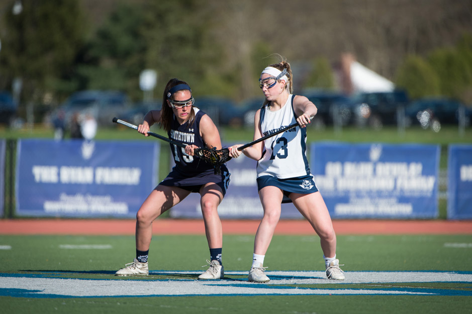 Emma Greenhill (right) faces off for Huntington. 