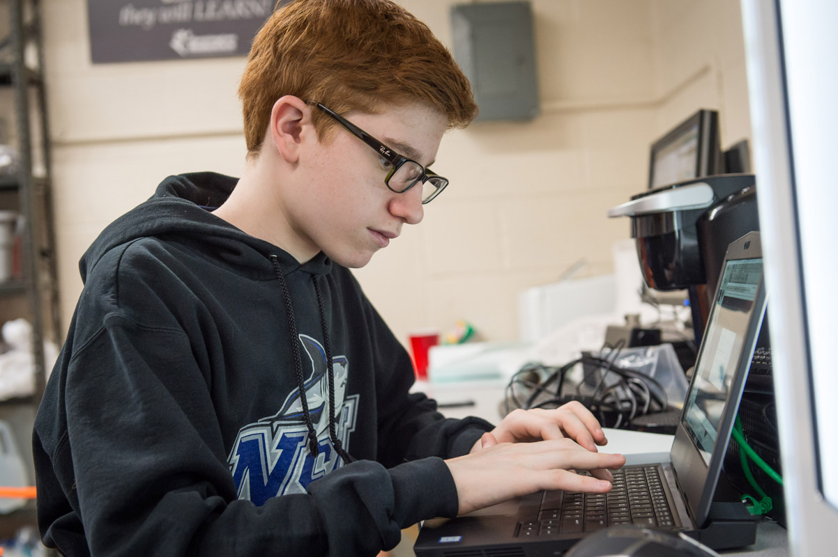 The Huntington robotics team is busy building and programming its robot for competition. (Darin Reed photo.)