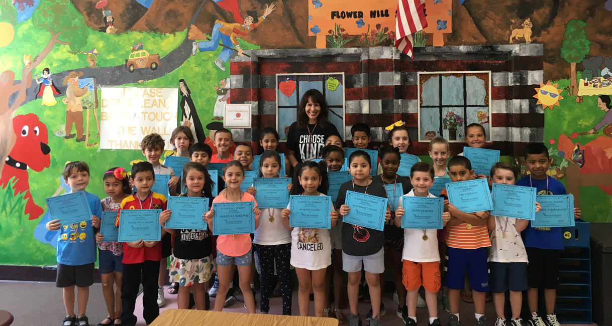 Flower Hill Principal Lucia Laguarda with June's Star Student Award recipients.
