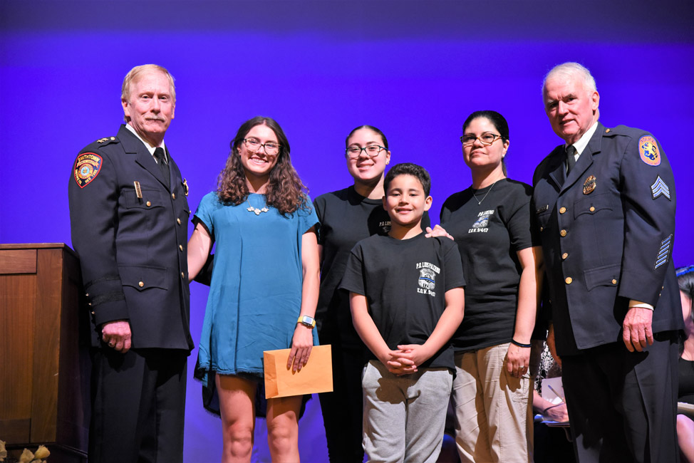 Alexandra McKenzie (second from left) with Nassau Police officials and Palermo family members