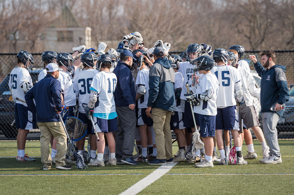 The 2018 Huntington varsity boys' lacrosse team huddles. (Darin Reed photo.)