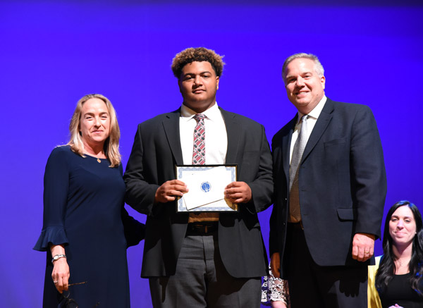 Huntington Alumni Assn. officers Emily Rogan and Tom DiGiacomo flank scholarship recipient Clay Jamison 