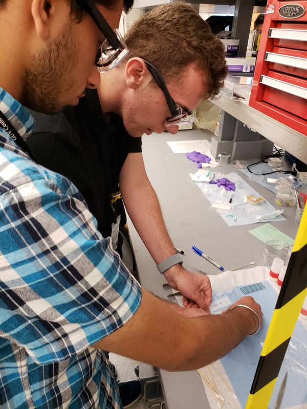 Huntington students Ryan Hoffmann and Arashdeep Singh and teacher Dame Forbes trained at Brookhaven National Lab last week