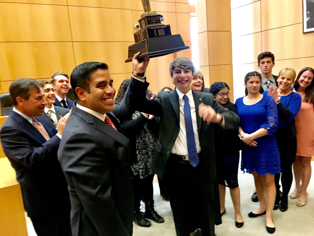 Max Robins with Huntington mock trial team legal advisor Xavier Palacios and teammates after winning the county title.