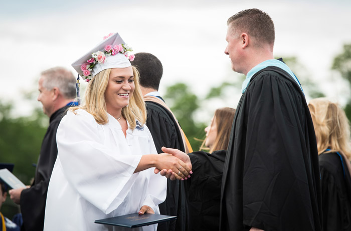 Principal Brenden Cusack congratulated senior Sarah Agrillo on the stage. (Darin Reed photo.)