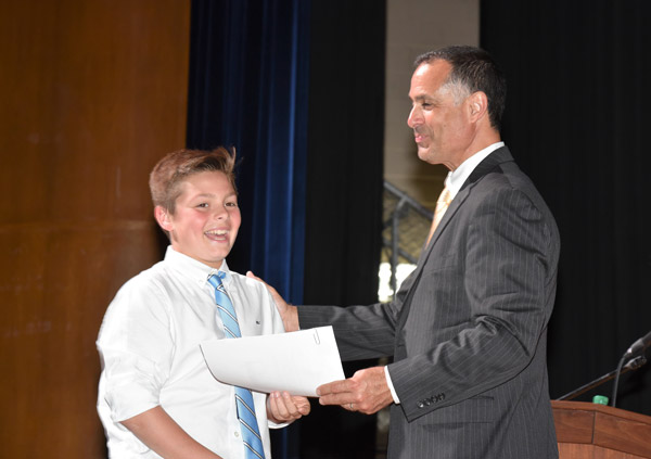 Finley Principal John Amato presented each eighth grader with a certificate.