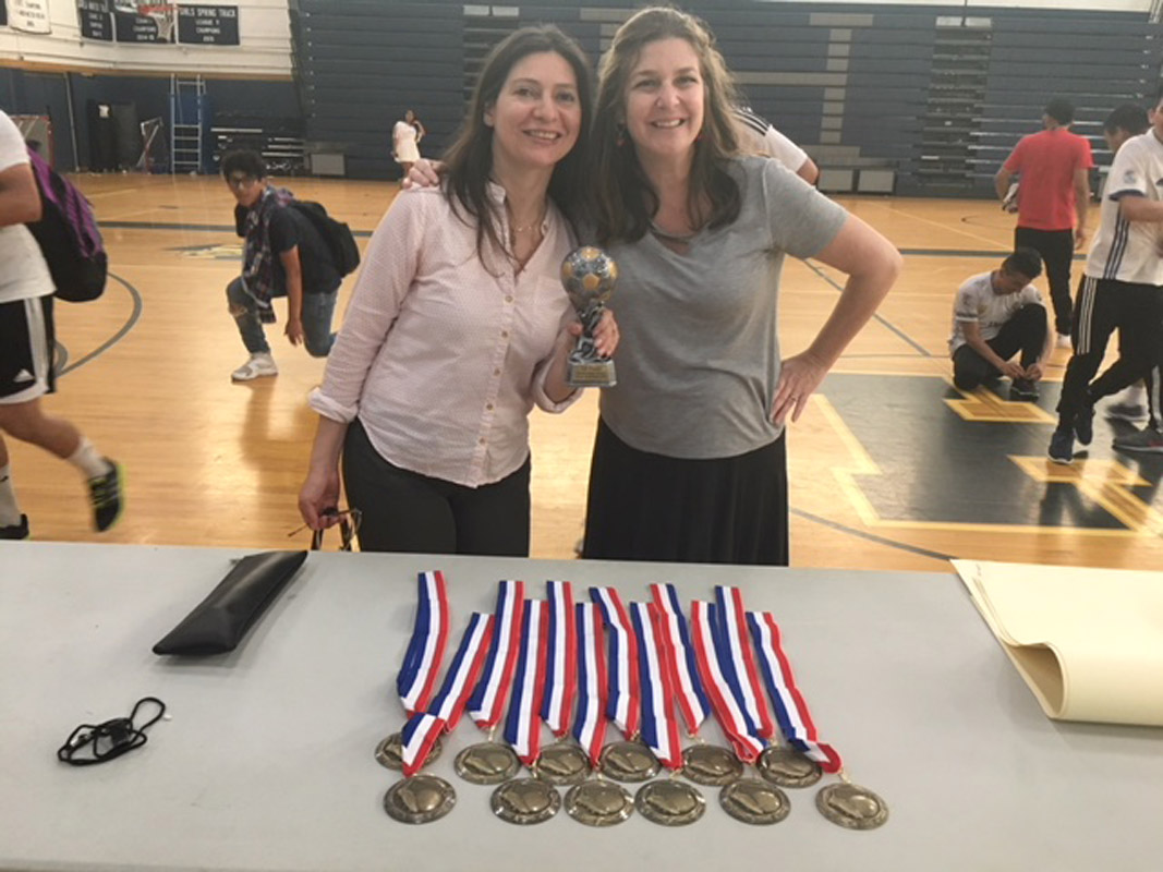 Spanish Honor Society advisors Maria Gonzalez and Nadine Araoz stand near the awards table..