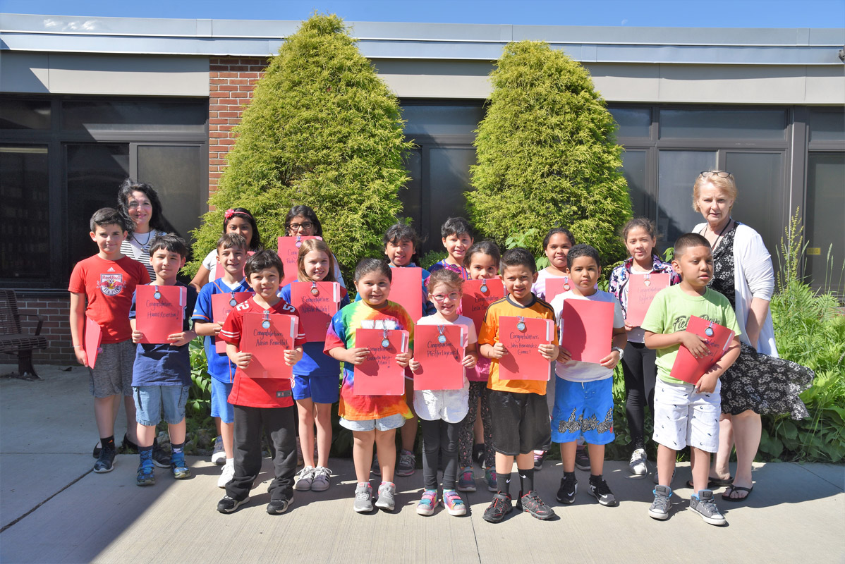 Teacher Maria Mazzola and Principal Marsha Neville with June's Featured Artists of the Month