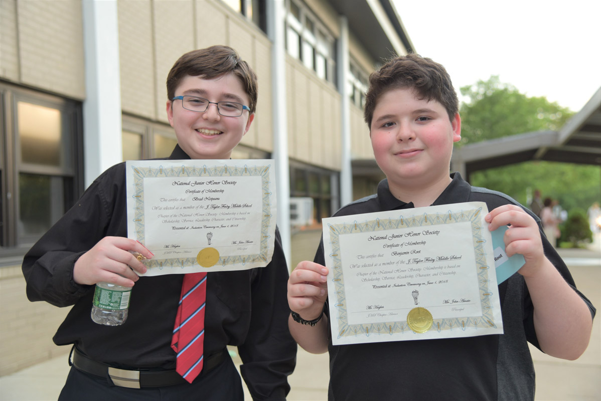 Brad Nisipeanu and Benjamin Root show off their membership certificates.