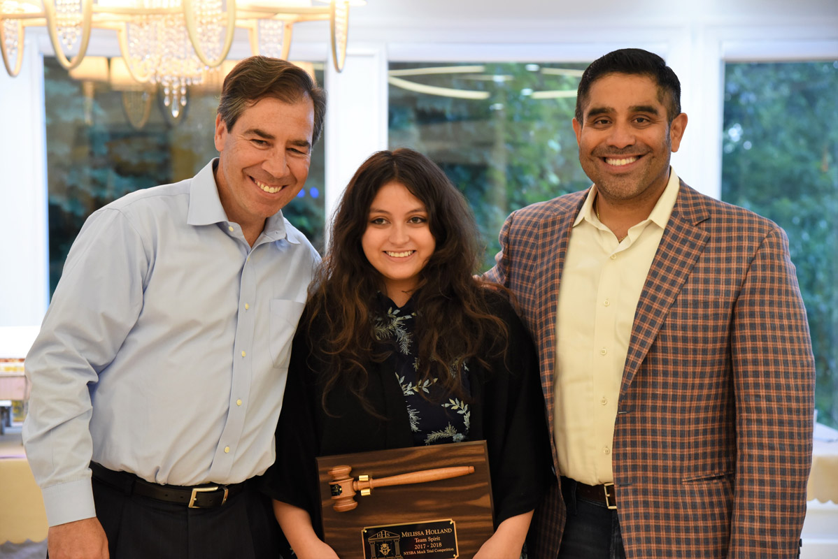 Team Spirit Award reciient Melissa Holland with legal advisors John LoTurco and Xavier Palacios.