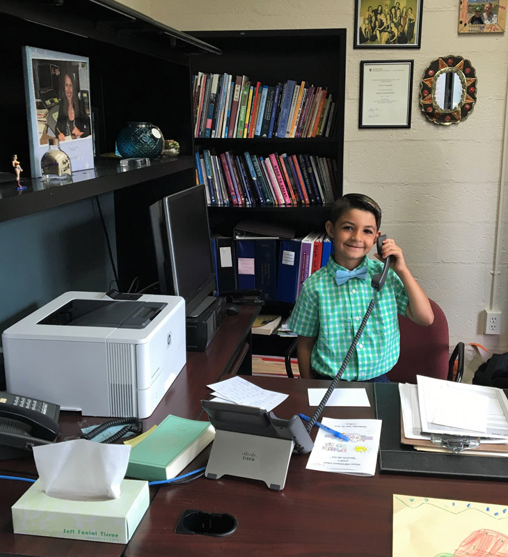 Domenico Leotta answers the phone in the Flower Hill principal's office.