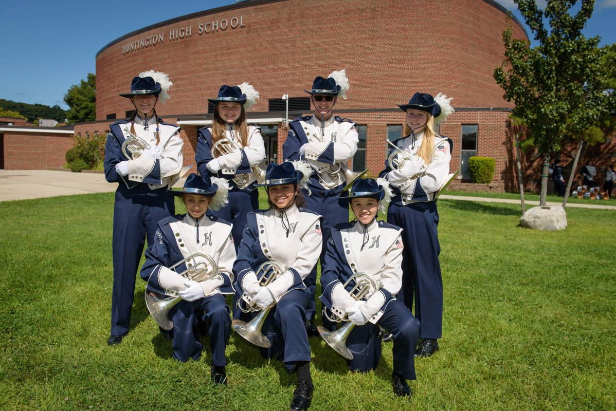 Amelia Reilly (back row right) holds a mellophone and stands with brass section members. (Darin Reed photo.