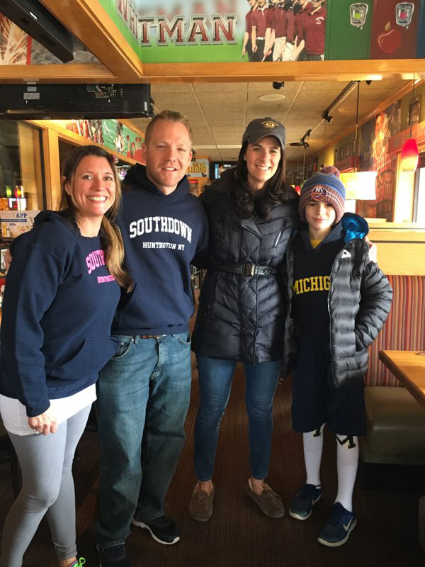 Principal Scott Oshrin (second from left) at Applebee's for the pancake breakfast.