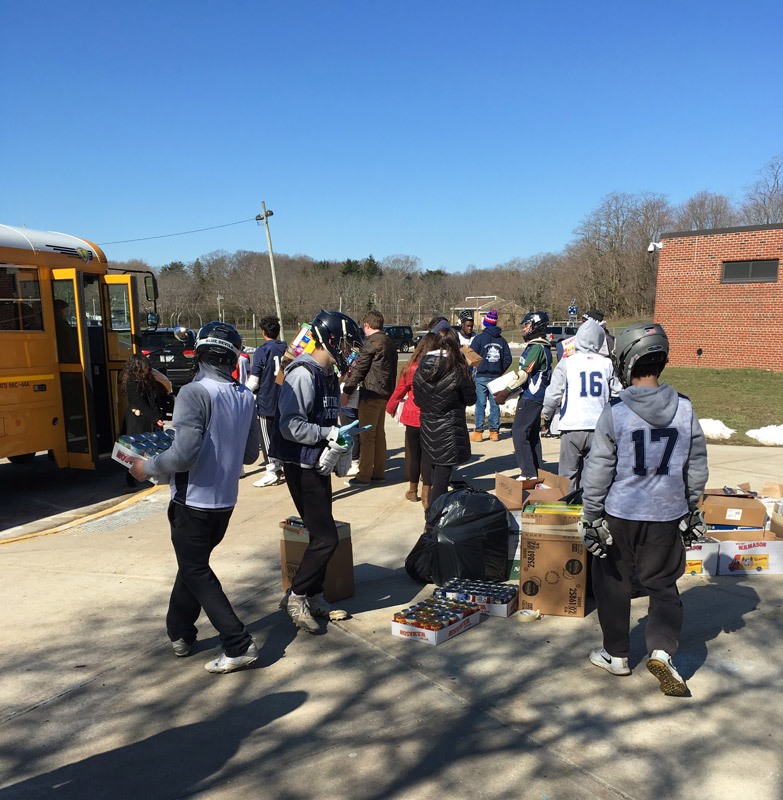 JV lacrosse players helped stuff the bus.