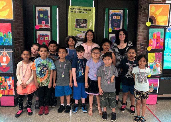 Jefferson Primary School art teacher Maria Mazzola with the Featured Artists of the Month for May.