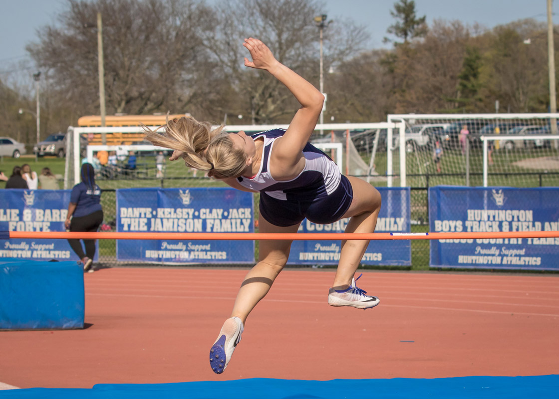 Senior Katie Seccafico clears the high jump bar. (Mike Connell photo.).