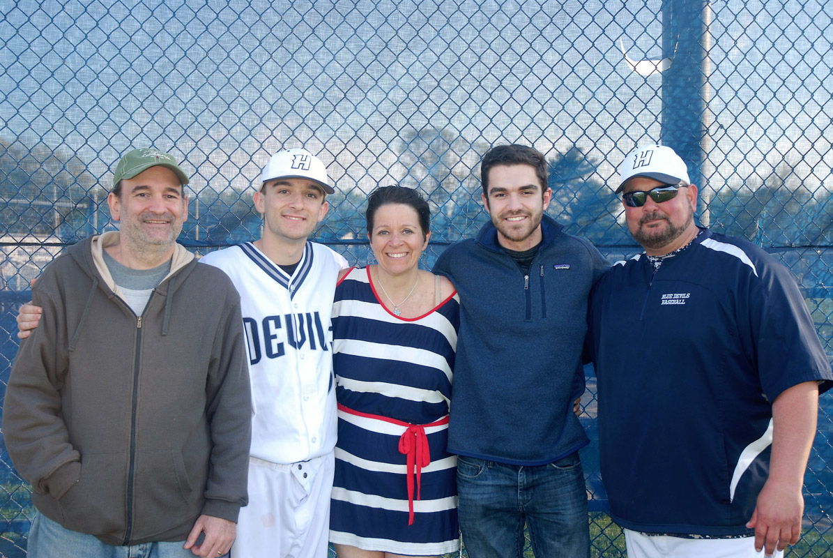 David Fredericks (in uniform) with his parents and brother and head coach Billy Harris..