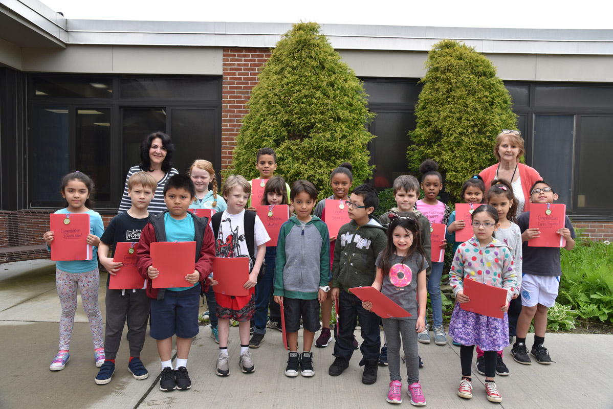 Art teacher Maria Mazzola and Principal Marsha Neville with May's Featured Artists.